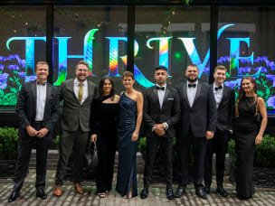  Eight people attending the annual Black Tie Gala, dressed in formal evening wear.
